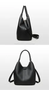 Dettagli della borsa a secchiello in pelle nera con hardware dorato e tracolla