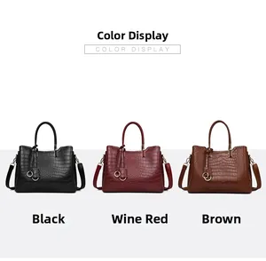 Embossed leather tote bags in black, wine red, and brown colors with metal charms