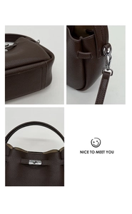 Detailed views of silver twist lock, stitching, and shoulder strap on brown leather bucket bag