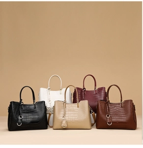 Five crocodile embossed handbags in black, white, beige, burgundy and tan colors