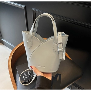 Detail of light blue bucket bag with silver hardware and adjustable shoulder strap