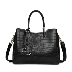 Elegant black crocodile-embossed tote bag with gold hardware and removable shoulder strap