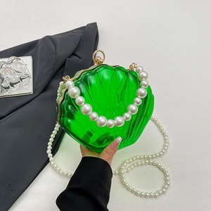 Green shell-shaped acrylic evening bag with pearl chain handle and gold ball clasp