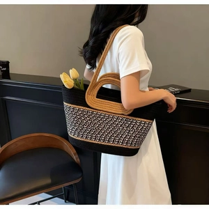 Detail of large woven tote bag with geometric pattern and rope handle for beach vacation