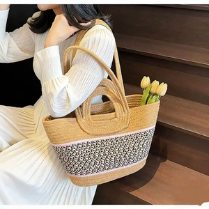 Close-up of color-block straw tote bag with round handles and woven texture on stairs