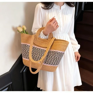 Large straw tote bag with pink stripes and black-white pattern for beach vacations
