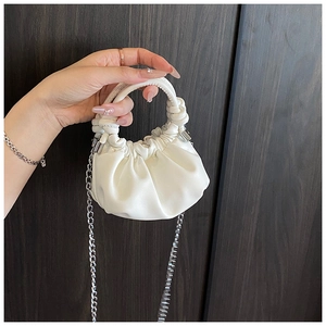Detail of white pleated cloud bag showing soft PU texture and silver chain strap