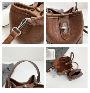 Detail view of brown pebbled leather bucket bag showing silver hardware and inner pouch