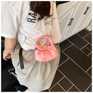 Pink pleated cloud bag with silver chain strap shown as a crossbody mini purse