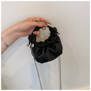 Detail of black ruched mini cloud bag with knotted handle and silver chain strap