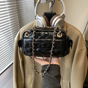 Chic black quilted leather crossbody bag with elegant gold chain strap in 45-degree view