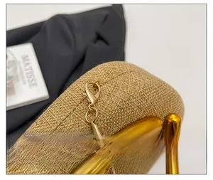 Macro detail of golden metal clasp and woven jute texture on vintage shoulder bag