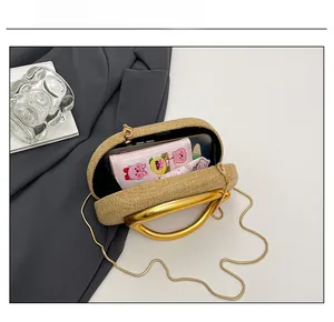 Internal capacity of the woven bag showing phone and cosmetics with golden handle