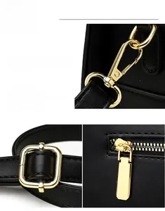 Gros plan sur la garniture dorée polie et le cuir noir grainé de ce petit sac à main carré