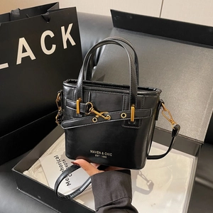 Vintage black leather bucket bag with MAVEN & CHIC logo, double handles and gold strap
