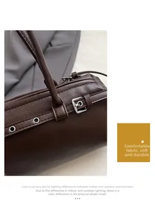 Detail of dark brown lychee leather bag featuring silver buckles and eyelets