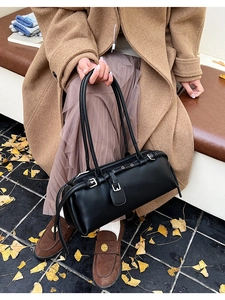 Classic black faux leather shoulder bag with sleek silver buckles and long straps
