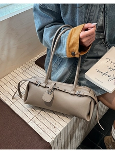 Macro shot of khaki rectangular faux leather bag with stylish buckle strap detailing