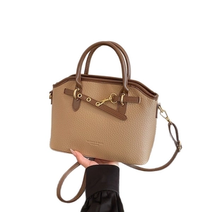Retro brown lychee leather handbag with dual handles and adjustable shoulder strap