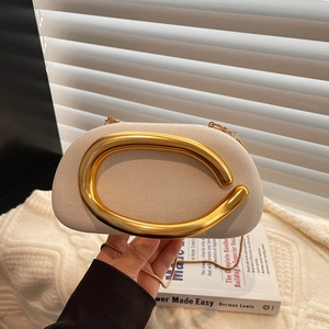 Vintage cream woven shoulder bag with sculptural gold metal handle and chain strap