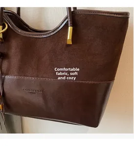 Close-up of dark coffee tote bag showing contrast stitching and suede leather texture
