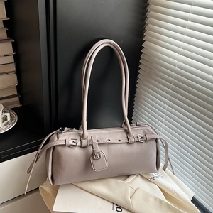 Modern grey faux leather shoulder bag with decorative silver buckle and underarm strap