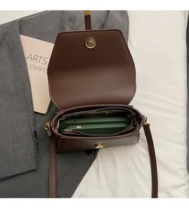 Interno dettagliato di una borsa in pelle opaca marrone con scomparti e chiusura magnetica