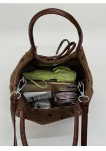 Spacious interior of brown wool bucket bag with star patterns showing daily essentials