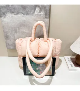 Pink quilted puffer tote bag detail showing large capacity with a tablet inside