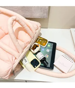 Internal view of pink puffer tote bag showing large capacity for tablet and cosmetics