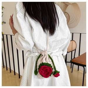 Detailed view of a handmade crochet crossbody bag with 3D floral rose patterns