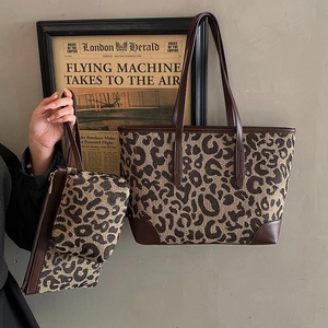 Leopard print tote bag set with brown faux leather handles and matching zipper pouch