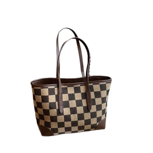 Checkered canvas tote bag with brown leather handles and reinforced corner patches