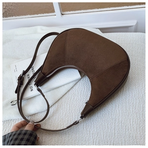 Detail of brown suede hobo bag showing material texture and silver metal zipper closure