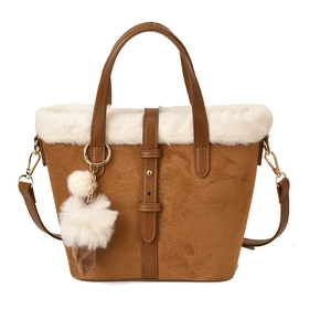 Brown suede tote bag with white faux fur trim and pom-pom charm for winter style