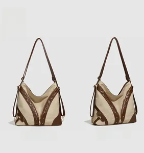 Vue avant et latérale du sac en toile kaki avec bordure en cuir marron et détail éclair en V