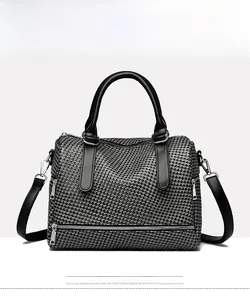 Front view of black houndstooth Boston handbag with silver zippers and crossbody strap