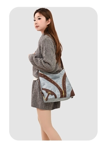 Détail du sac fourre-tout vintage avec boucle latérale et finitions en cuir marron