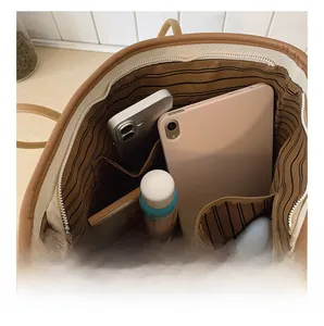 Detail view showing large capacity interior of a white tote bag with multiple pockets