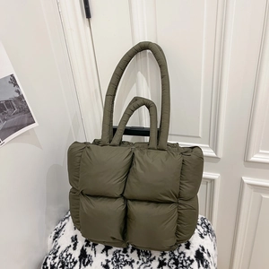 Olive green quilted puffer tote bag with padded handles and fluffy texture