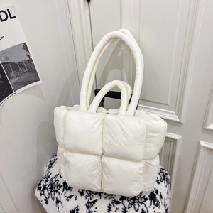 Minimalist white quilted down tote bag with dual handles for shoulder and hand carry