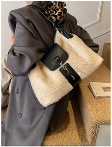 Detail of plush cream faux fur crossbody bag with black leather flap and shoulder strap