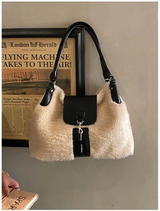 Detail of plush beige faux fur crossbody bag with black leather straps on retro background
