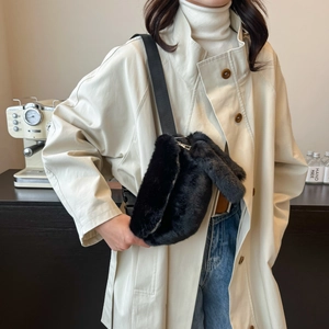 Chic black faux fur crossbody bag with silver zipper shown on a casual autumn outfit