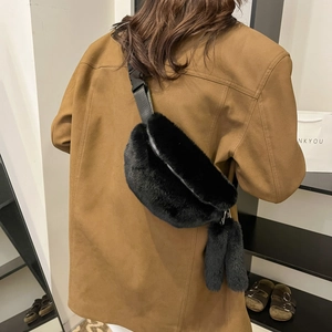 Black plush crossbody waist bag for winter with silver zipper and soft fur texture