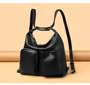 Detail of black pebbled leather backpack with two functional front utility pockets