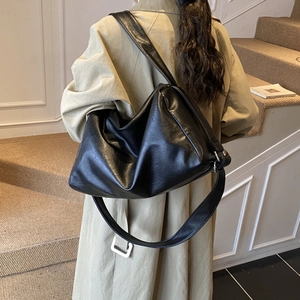 Minimalist black leather tote bag for women with high gloss finish in a shoulder style