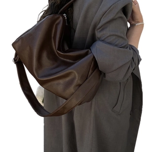 Minimalist large brown tote bag with wide strap and soft textured leather for women