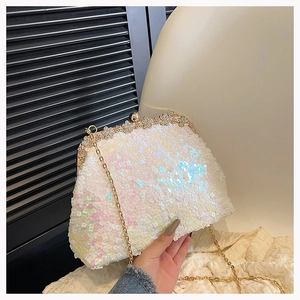 Close-up of sparkling sequin evening bag with crystal flower clasp and gold chain