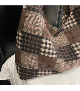Macro detail of retro plaid tote bag showing thick knitted texture and black button closure